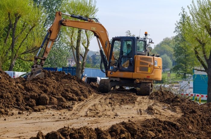 Tracked excavator moving earth on a construction site
